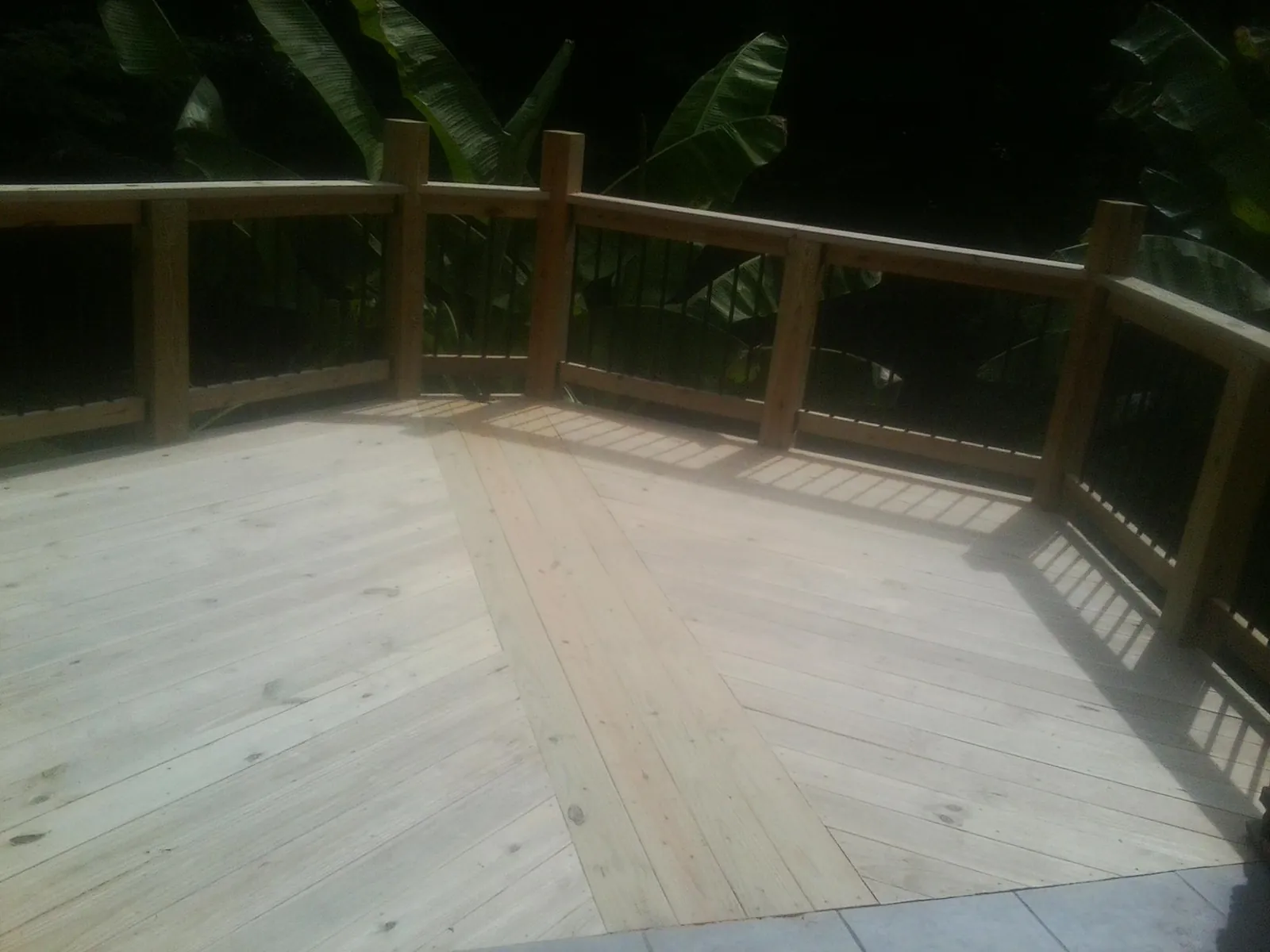 New wood deck and railing built off the back of a home in Masontown